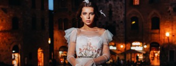 A bride in a white dress in the old town of San Gimignano.A girl walks around the city in Italy