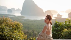 traveler woman enjoy Phang Nga bay, alone Tourist relaxing at Samet Nang She, near Phuket, Thailand