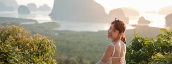 traveler woman enjoy Phang Nga bay, alone Tourist relaxing at Samet Nang She, near Phuket, Thailand