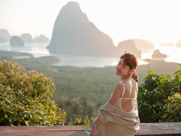 traveler woman enjoy Phang Nga bay, alone Tourist relaxing at Samet Nang She, near Phuket, Thailand
